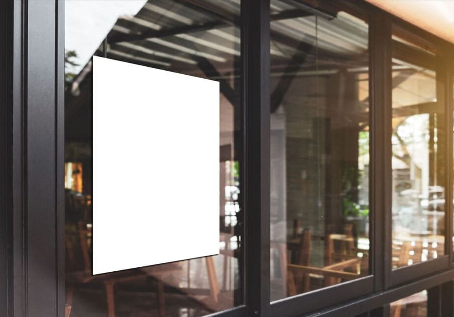 White paper poster mockup displayed outside the building restaurant. Marketing and business concept.